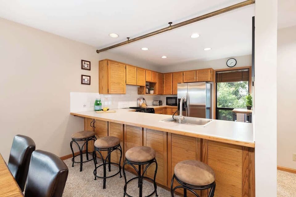 - Spacious kitchen with wooden cabinets and island  
- Stainless steel appliances ready for cooking ease  
- Perfect setup for family meals and group dining  