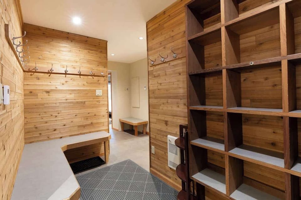 - Mudroom with built-in cubbies and storage benches  
- Ideal for organizing ski gear and outdoor essentials  
- Warm wood accents create a welcoming mountain entry  