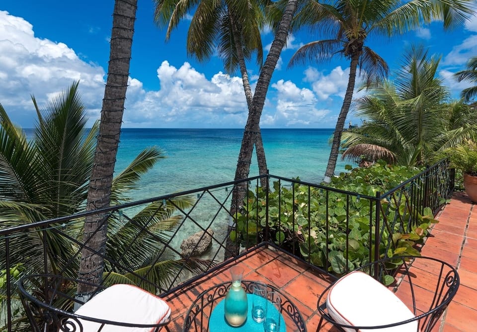 The pool deck has a cliff-top view over the ocean