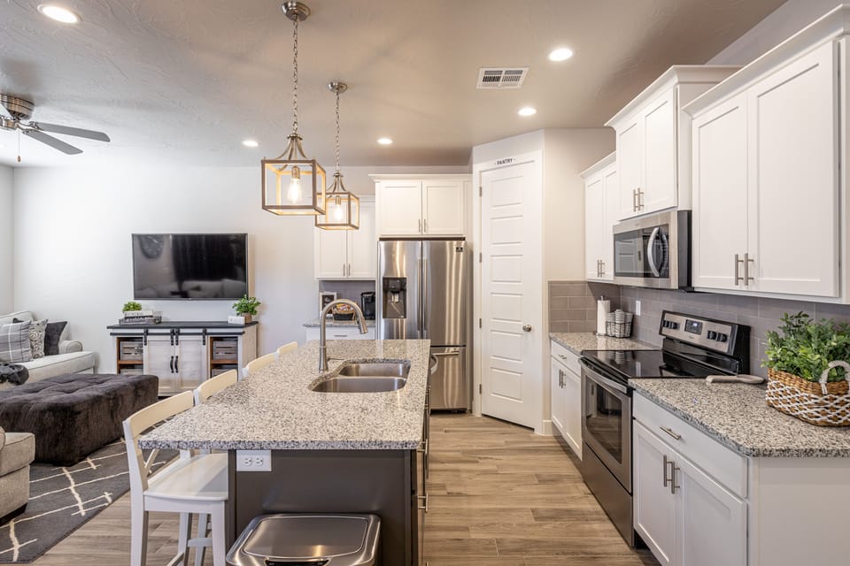 Kitchen - The kitchen is fully stocked with all the dishes, cookware, baking pans, and cutlery you will need for meal preparations and includes stainless steel appliances and granite counter tops.