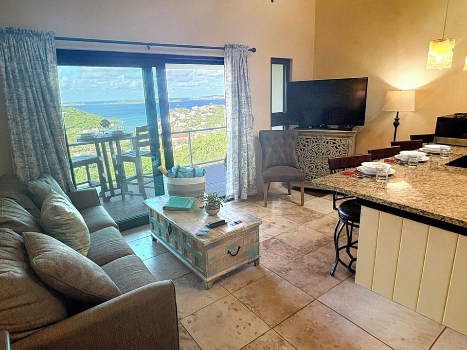 The great room at Pina Coladas looks out to the private balcony and stunning ocean views