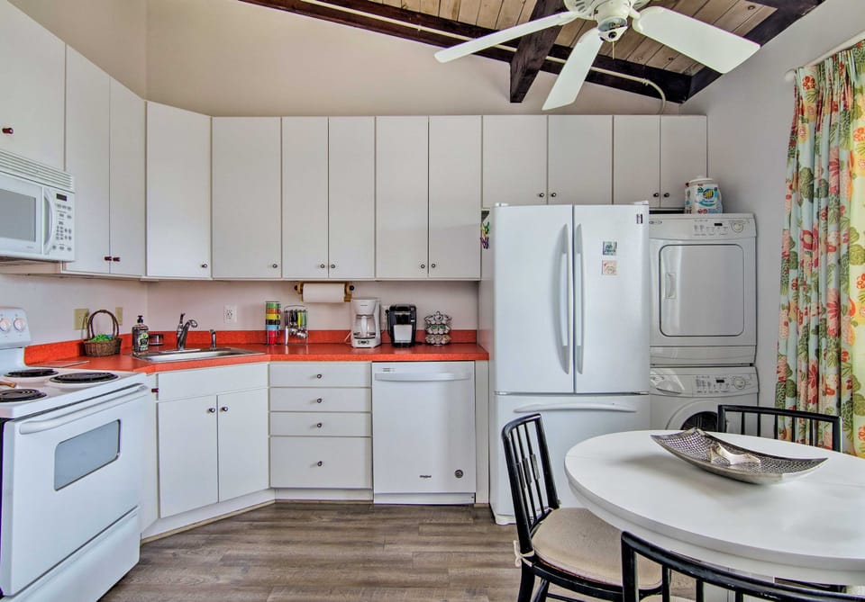 This kitchen features a 4-person dining table and all your cooking essentials.