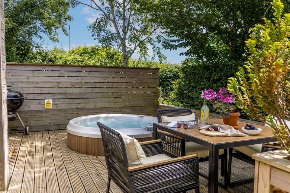 Decking in garden space with BBQ, Hot tub, dining table - The Retreat