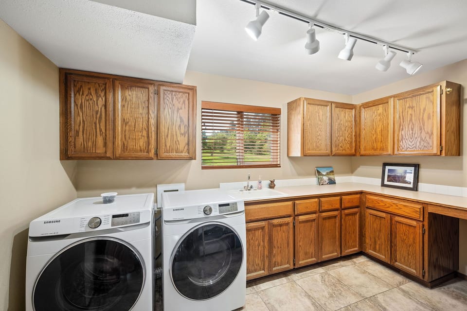 Your spacious laundry room features modern appliances and ample cabinet storage, making it easy to keep your belongings fresh during your stay.
