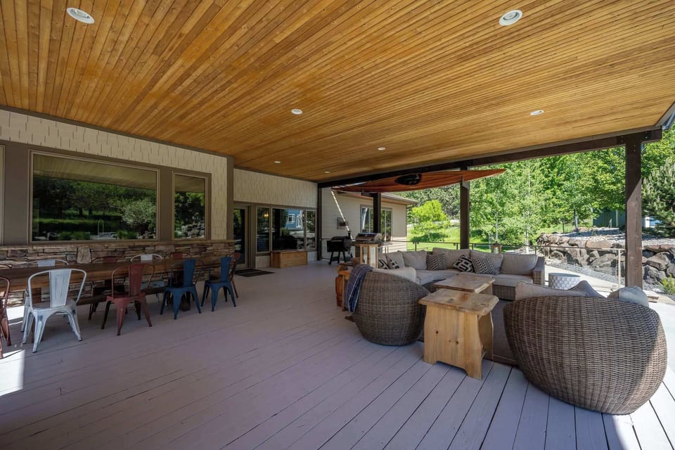 Relax in your stylish covered patio with cozy wicker seating, dining space, and BBQ area—perfect for entertaining outdoors.