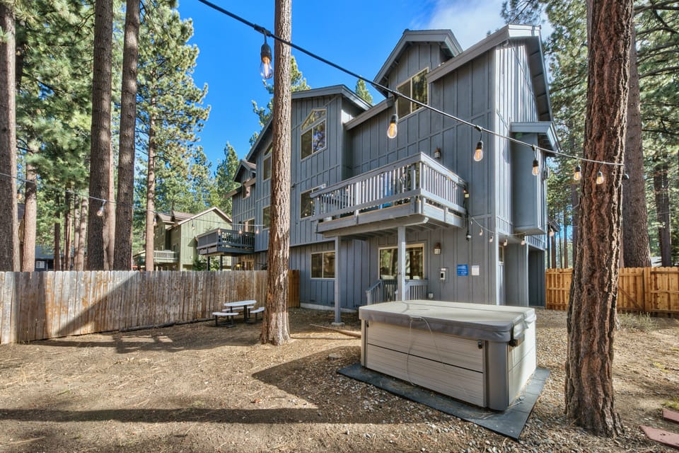 Soak under the stars in your private hot tub, surrounded by towering pines and twinkling lights.
