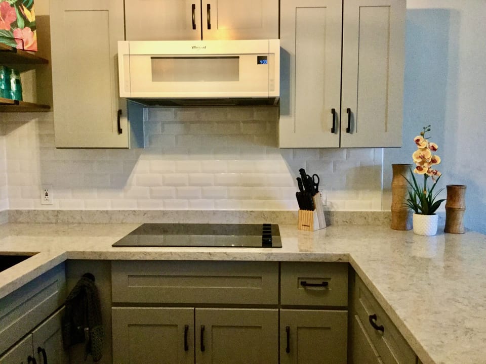 Whirlpool stovetop and microwave oven plus many small appliances 