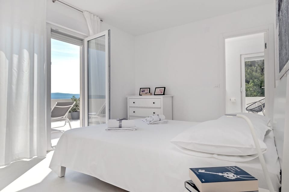 Bedroom on the 2nd floor with a double bed, bathroom, and exit to balcony 