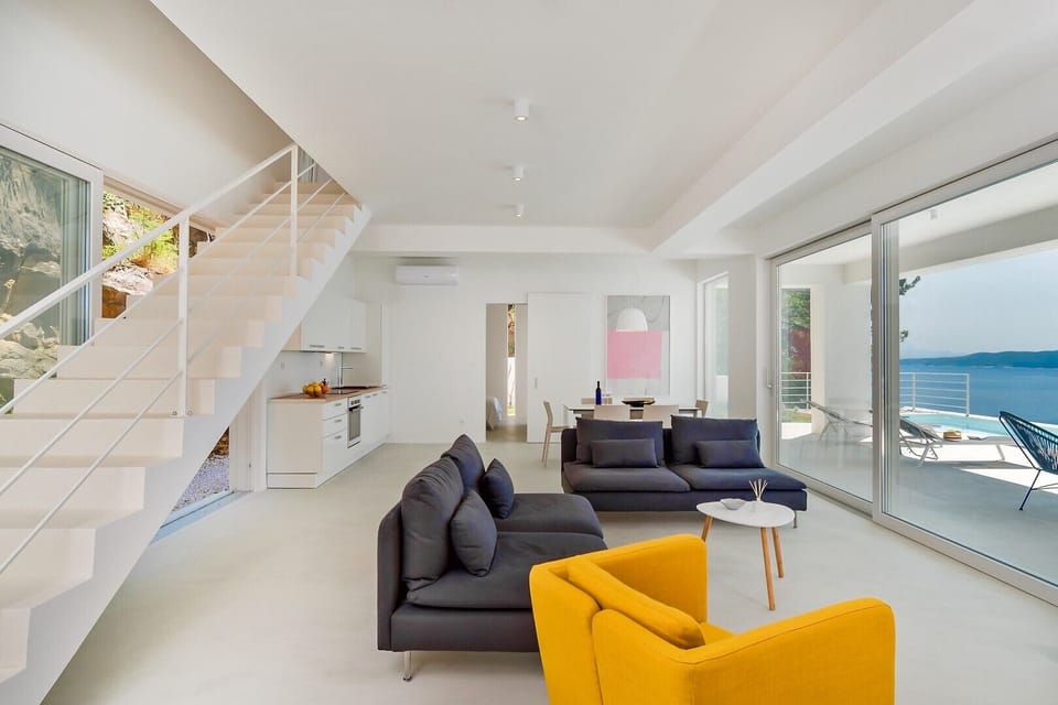 Modern living area and stairs for upper floor with two bedrooms
