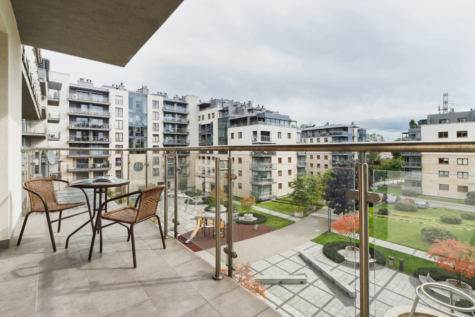 A view from the balcony overlooking a landscaped courtyard with gardens and walking paths.