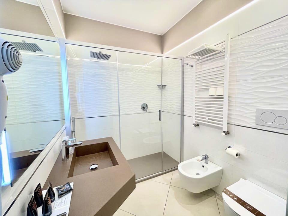 Deluxe Quadruple Room, Multiple Beds, City View | Bathroom | Shower, rainfall showerhead, free toiletries, hair dryer