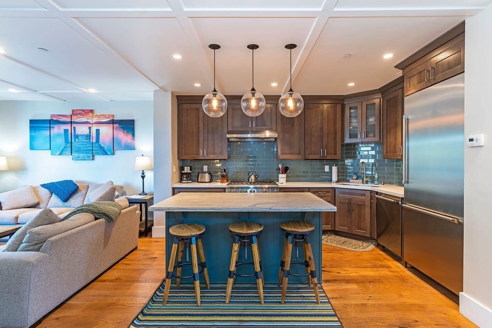 The kitchen is equipped with top of the line appliances and pendant lighting