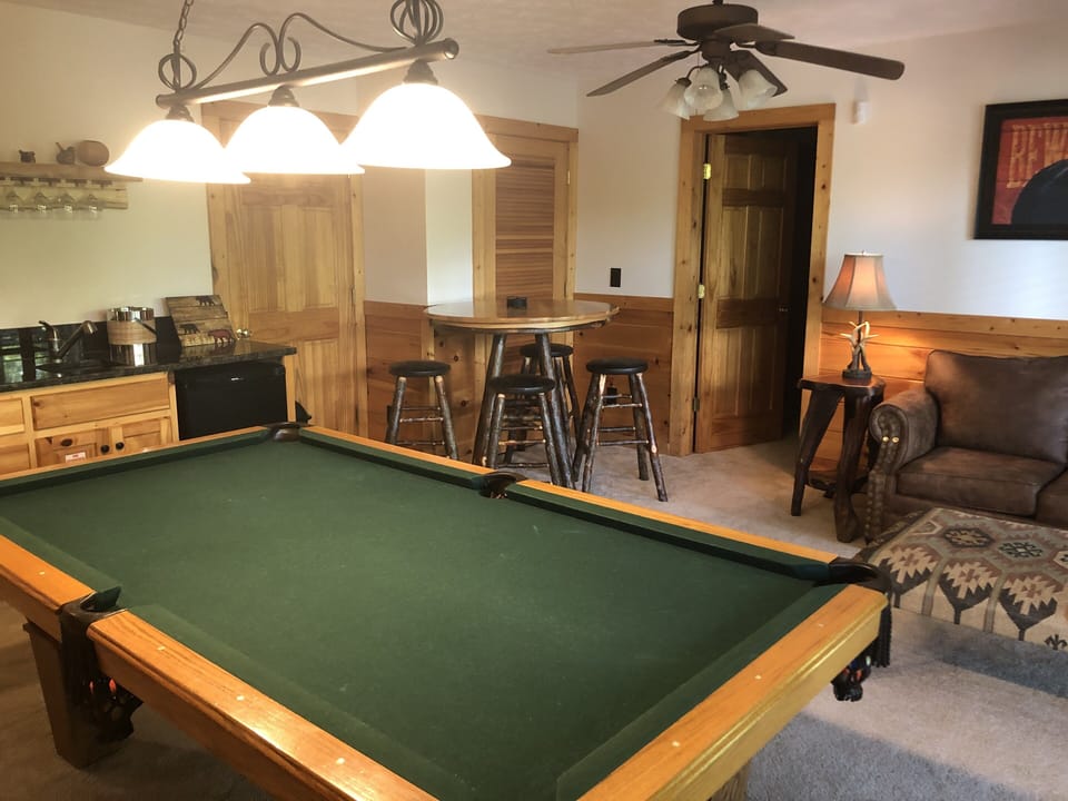Game room with bistro table for playing board games or cards.