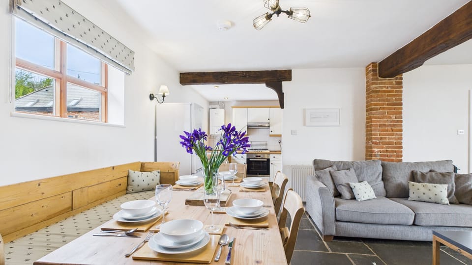 Gather for family meals at the rustic wooden dining table, which comfortably seats six guests.