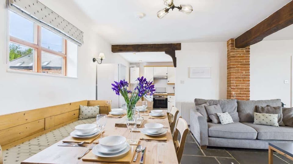 Gather for family meals at the rustic wooden dining table, which comfortably seats six guests.