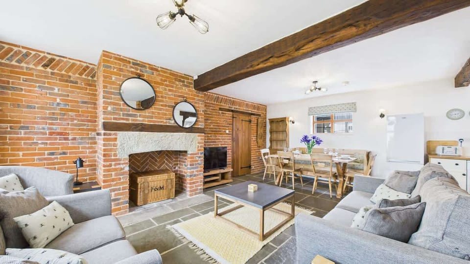 A bright and airy sitting area that blends rustic charm with modern comforts in an open-plan layout.
