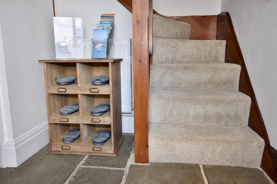 Staircase up to the first floor with local information leaflets.