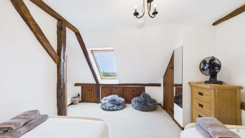 A second view of the twin room showing the ample storage and bright, welcoming decor.
