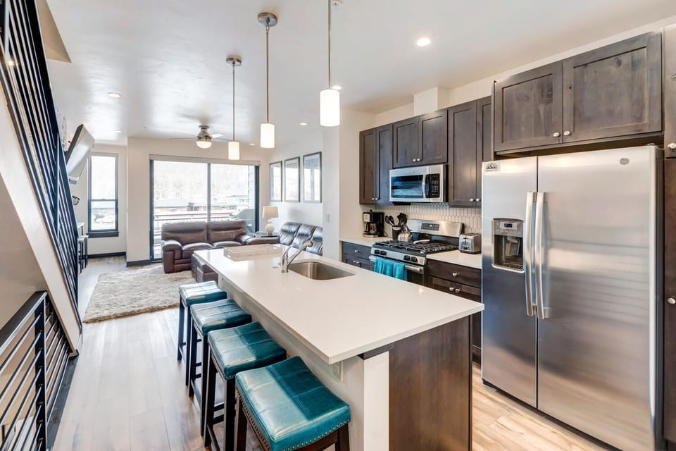 Modern Kitchen with Large Island and Blue Bar Seating
