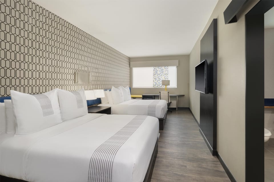 Premium bedding, memory foam beds, laptop workspace, blackout drapes