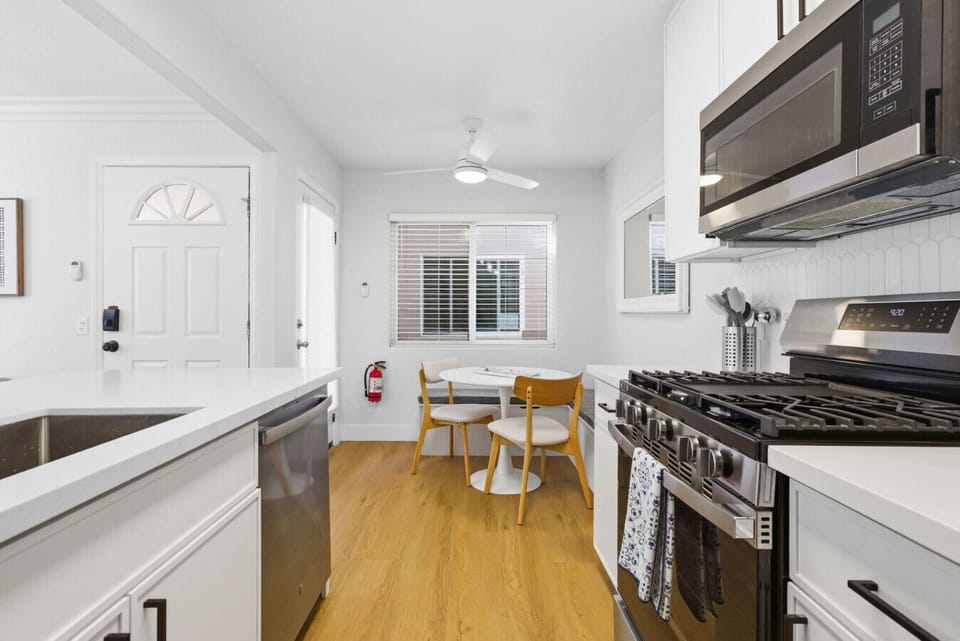 Fully equipped galley kitchen with dining nook and direct entry access.