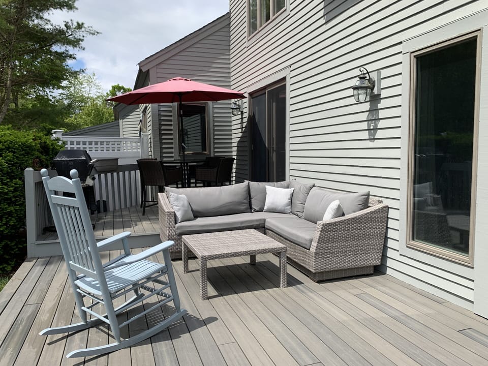 Backyard seating area with comfy couch and rocking chair