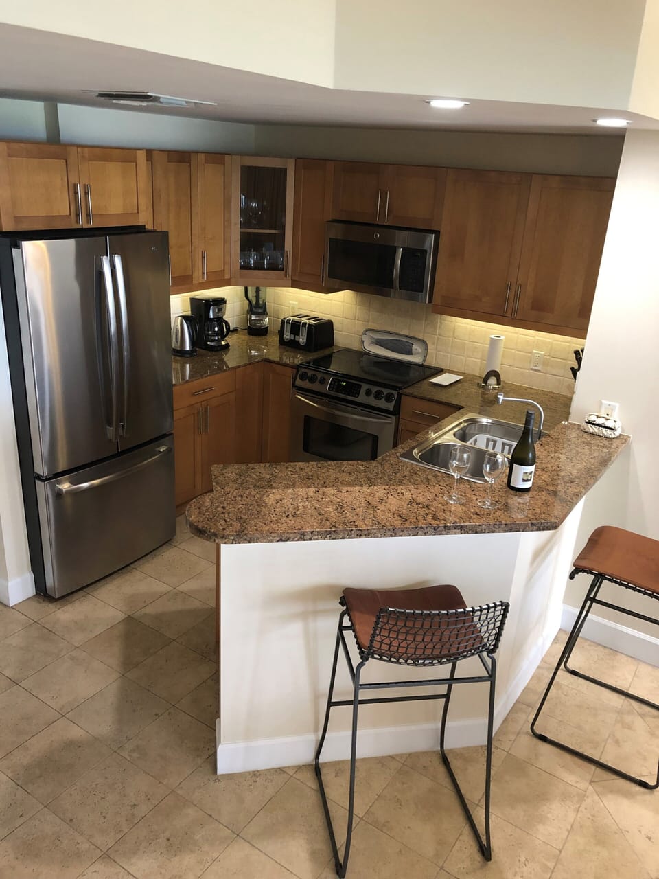 Fully stocked kitchen with stainless steel appliances and granite counter tops
