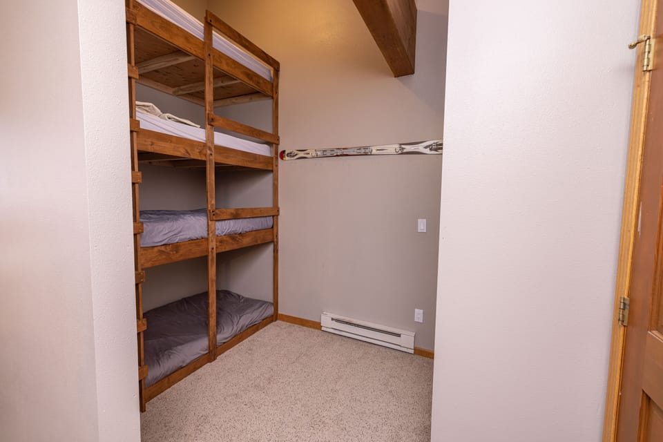 Bunk beds separated from the main sleeping area by partial wall.