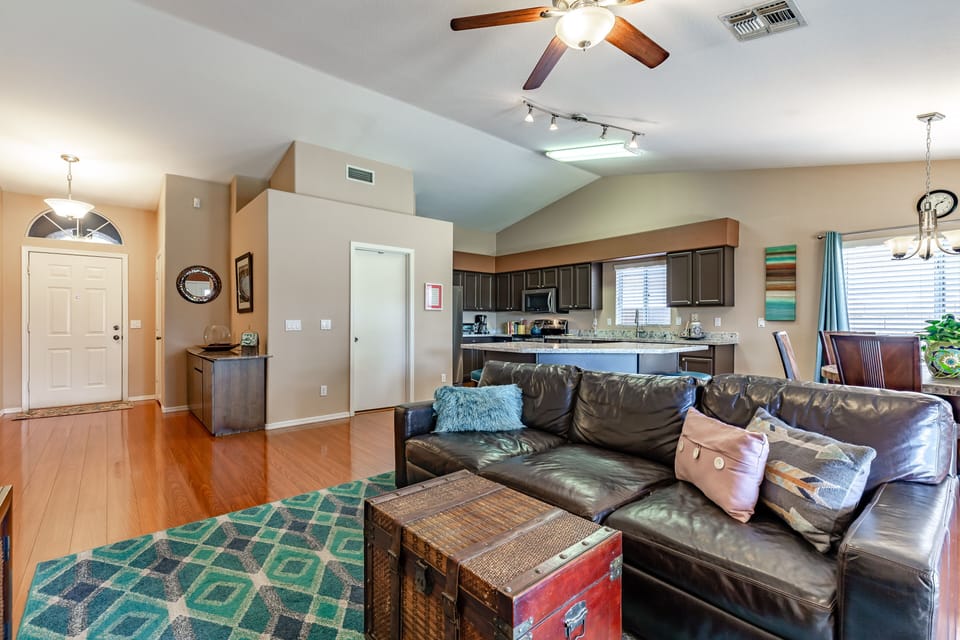 Living area dominated by a large, plush leather sofa.