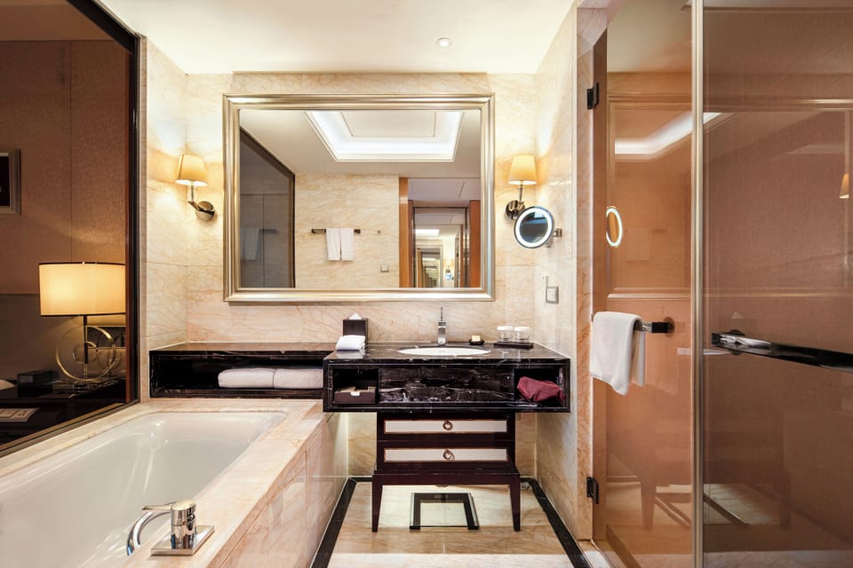 Separate tub and shower, hydromassage showerhead, designer toiletries