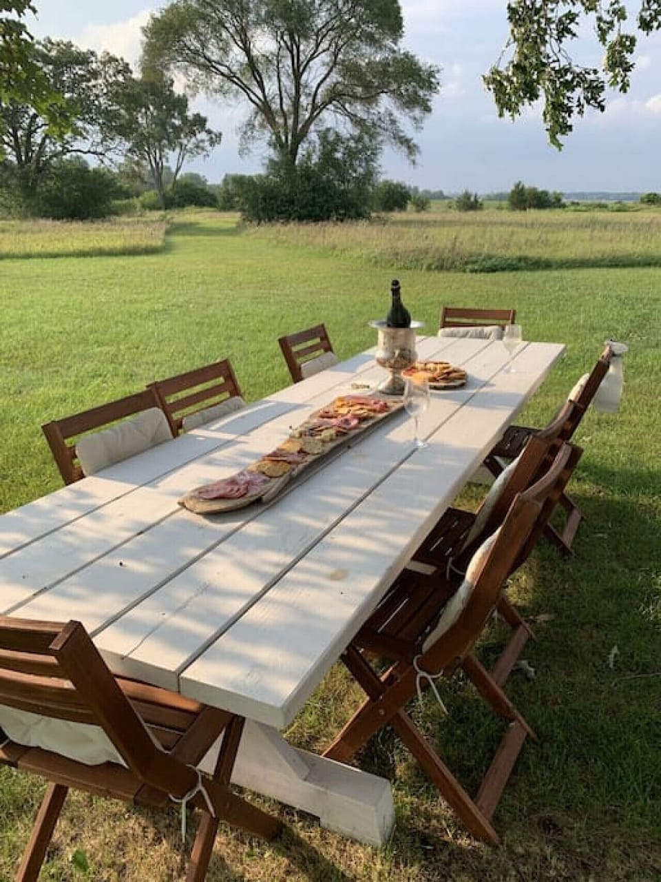 We custom built this 10 foot Tuscan style harvest table which sits under the 160 year old oak tree. Its a wonderful spot for all your meals and has views of the property and beyond.