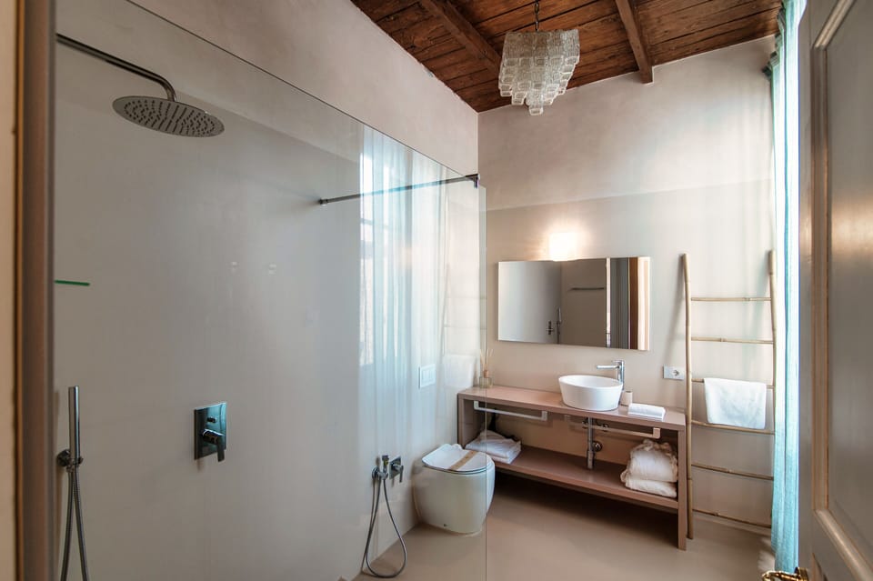Studio Suite | Bathroom | Hair dryer, slippers, towels, soap