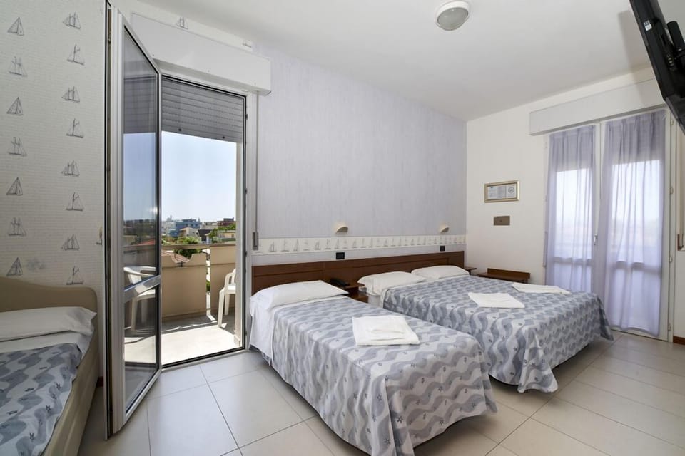 Quadruple Room, Partial Sea View | In-room safe, individually decorated, desk, laptop workspace
