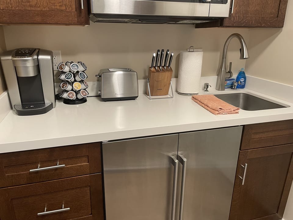 Beautiful kitchenette with small refrigerator/freezer. 