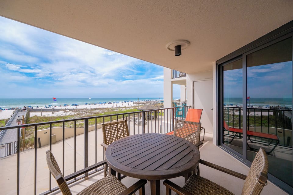 Cool breezes brush your skin as you unwind on the balcony's cozy chairs on your beachfront balcony