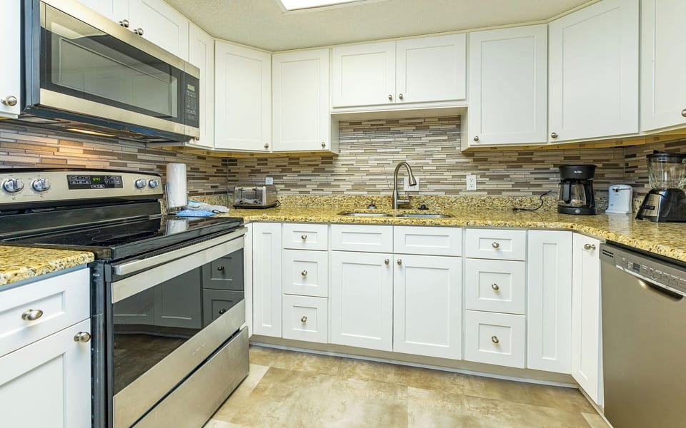 Beautiful granite countertops, a sleek stainless steel sink, and a stylish kitchen designed for both beauty and function