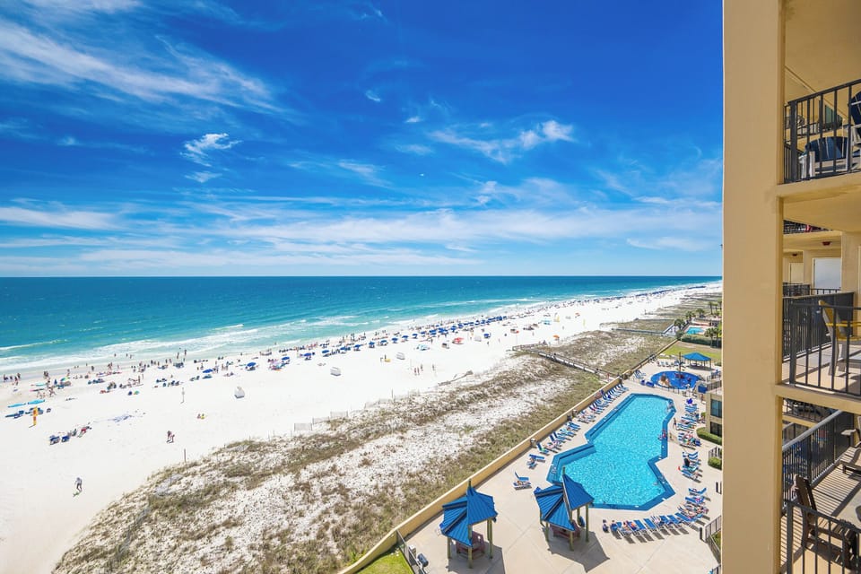 Your view from the balcony captures sparkling pool waters and the gentle waves along the coast below