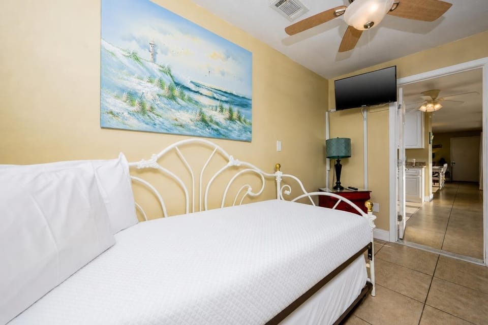 Cozy bedroom features a twin daybed with a twin trundle bed and TV, perfect for relaxation