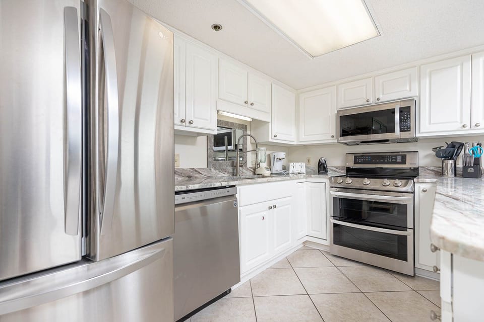 Cook and gather in this stylish kitchen featuring stainless appliances and elegant countertops