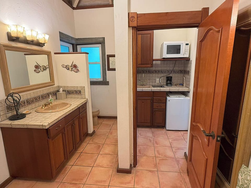 The upper guest house bathroom showing the vanity and kitchenette