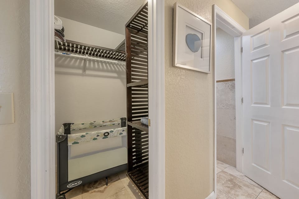 Closet in master with infant sleeping equipment.