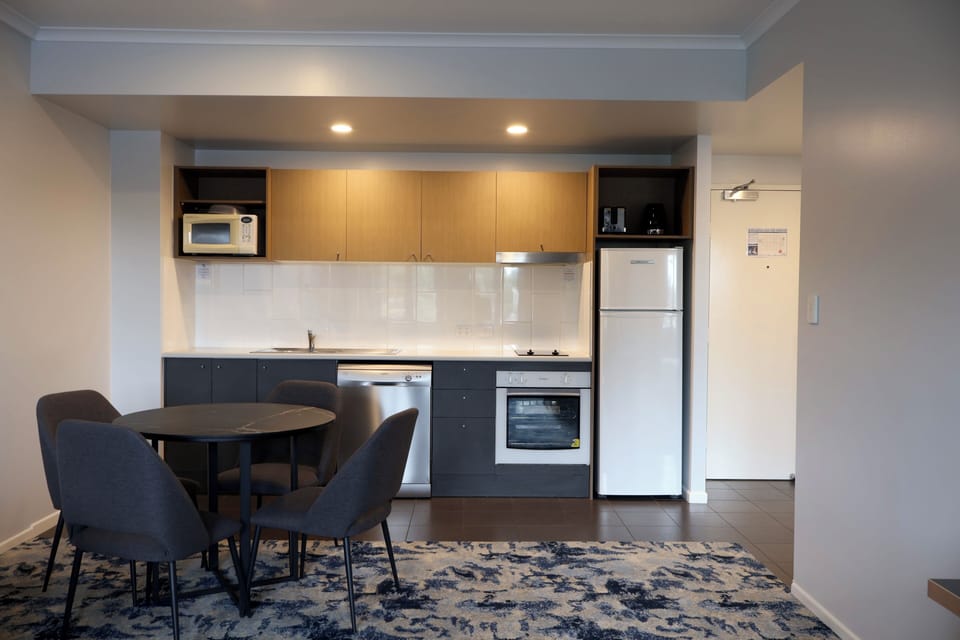 Deluxe 1 Bedroom Apartment | Private kitchen | Coffee/tea maker, full-size fridge
