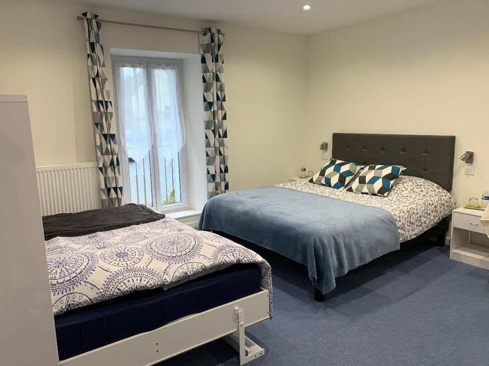 Family Room, 2 Queen Beds | Iron/ironing board, free cribs/infant beds, free WiFi, bed sheets