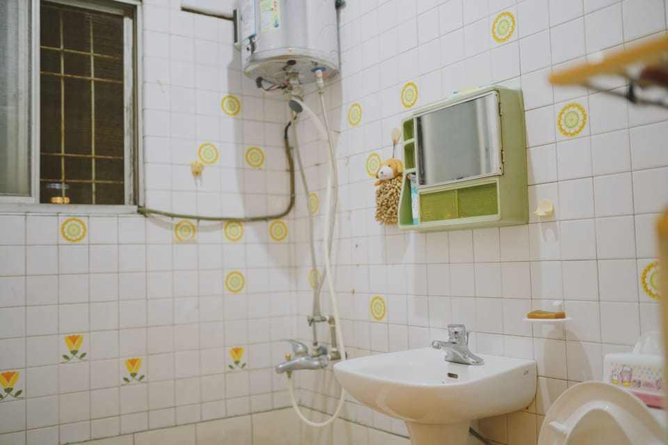 Shower, hair dryer, slippers, towels