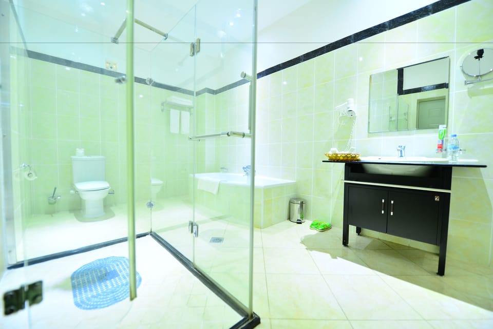 Separate tub and shower, rainfall showerhead, designer toiletries