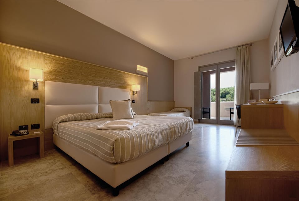 Superior Triple Room | Minibar, in-room safe, desk, laptop workspace