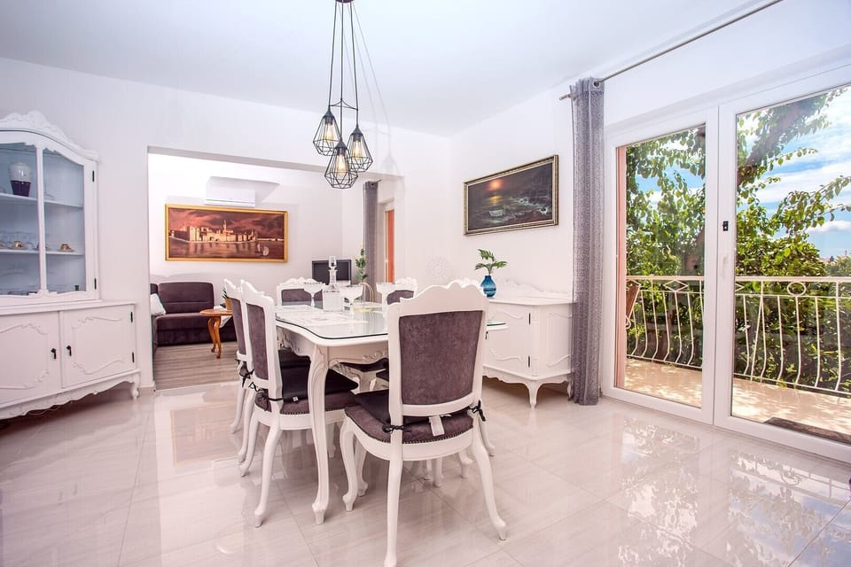 Dining and living area with A/C,  balcony and sea views