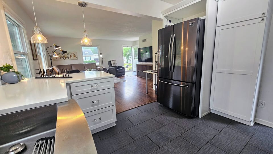 A view of the open concept kitchen and living room! TV is 65 inches! 