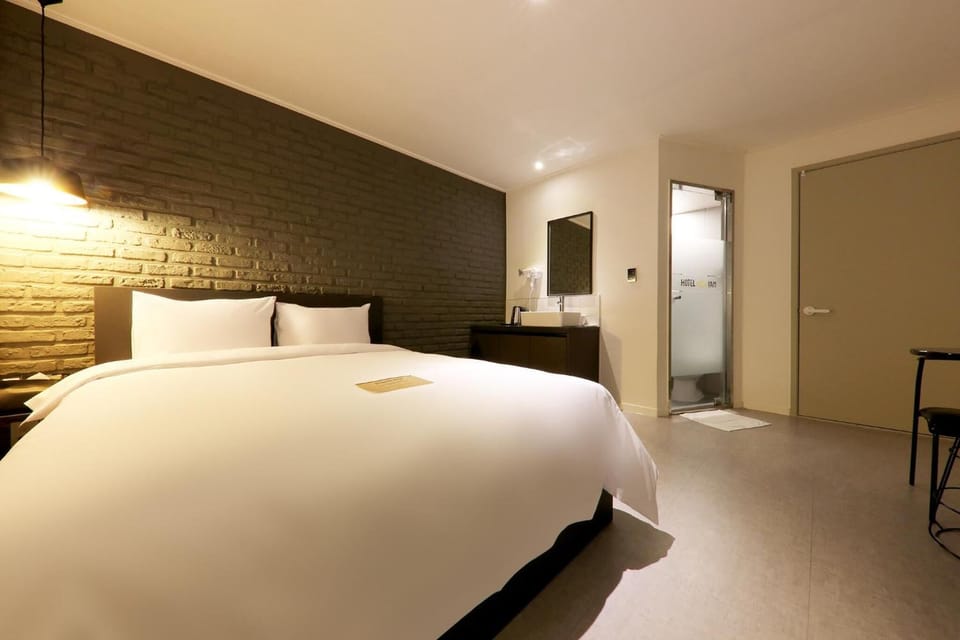 Premium bedding, desk, laptop workspace, blackout drapes