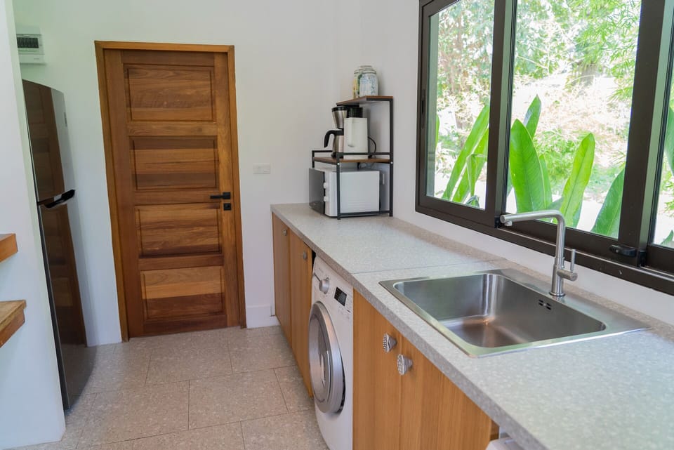 Comfort Villa | Private kitchen | Fridge, shared microwave, highchair, dining table